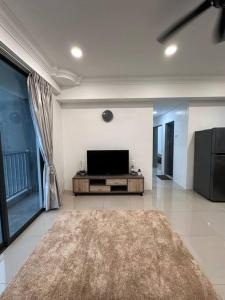 a living room with a flat screen tv on the wall at Minimalist City View Home with 3BR at Meru Ipoh in Bandar Meru Raya