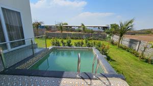 a swimming pool in the backyard of a house at White Lotus Villa in Pune
