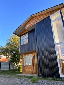 a house with black corrugated metal at Casas Altos del Simpson in Coihaique
