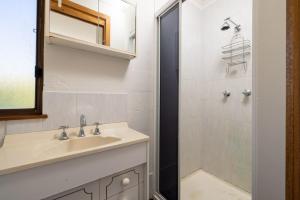 a bathroom with a sink and a shower at Bere Pad in Jindabyne