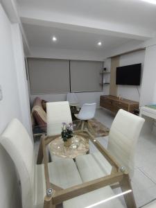 a living room with a table and white chairs at Apartamento moderno frente al mar in Cartagena de Indias