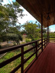 a wooden porch with a view of a field at Cabañas Ecowasi in Tingo María
