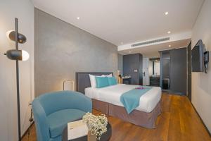 Łóżko lub łóżka w pokoju w obiekcie The Code Hotel & Spa Da Nang