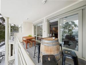 a wine barrel on the balcony of a house at Inala 7 in Thredbo