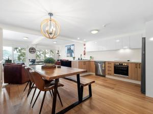 a kitchen with a table and chairs in a room at Inala 7 in Thredbo