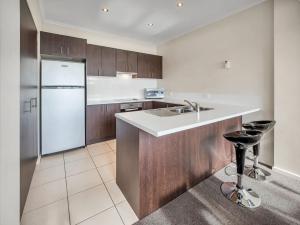 a kitchen with a sink and a refrigerator at Jasper 1 in Jindabyne
