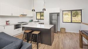 a kitchen with a large island in the middle at Kunama Haven in Jindabyne