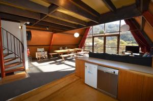 a large room with a kitchen and a dining room at Moonbah Ski Lodge in Thredbo