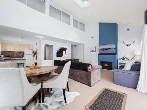 a living room with a table and a couch at Snowbound 1 in Thredbo