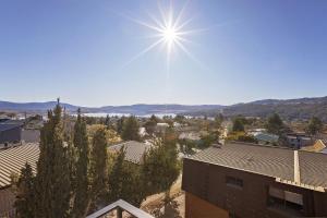 a view of a city with the sun in the sky at St Moritz 11 in Jindabyne
