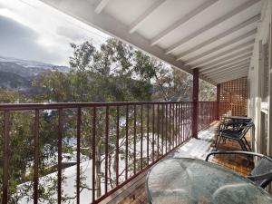 a balcony with a table and chairs on it at Tyrola 1 in Thredbo