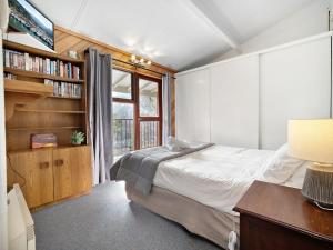 a bedroom with a bed and a book shelf at Tyrola 1 in Thredbo