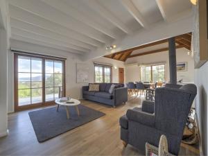 a living room with a couch and a table at Tulong LakEscape in Jindabyne