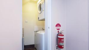 a bathroom with a fire hydrant next to a sink at Yurali in Jindabyne