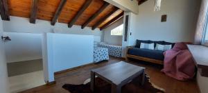 ein Wohnzimmer mit einem Sofa und einem Tisch in der Unterkunft Ribera de Cacheuta Lodge in Las Compuertas