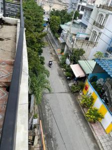 an empty street with a scooter parked on the sidewalk at QUỲNH HOA HOTEL in Ho Chi Minh City