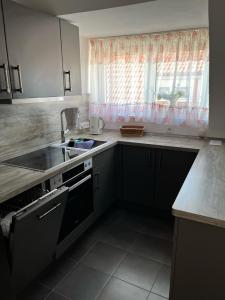 a kitchen with a sink and a stove and a window at 3-Zimmer-Wohnung Lichtenfels Schney in Lichtenfels