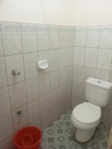 a bathroom with a white toilet in a room at The Beach Villa by M in Manguisoc