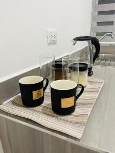 4 filiżanki kawy na tacy na blacie kuchennym w obiekcie InDomus Rooms w mieście Bacurimi