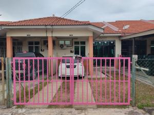 a pink gate in front of a house at Wan K Homestay Gua Musang in Gua Musang