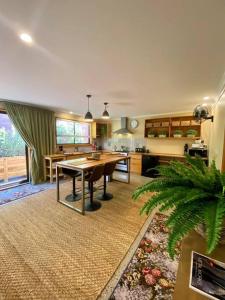 a large kitchen with a table in a room at A Destination To Delight! in Ballarat