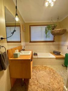 a bathroom with a sink and a bath tub at A Destination To Delight! in Ballarat