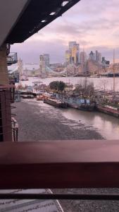 a view of a river with boats in a city at Riverside Private Room TowerBridge in London