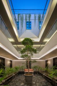 a tree in a pot in a room with plants at The Aldott Cyber City in Gurgaon