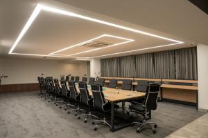 a conference room with a long table and chairs at The Aldott Cyber City in Gurgaon