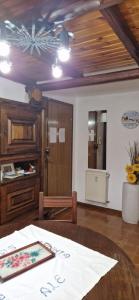 a dining room with a table and a ceiling at Casa Sofia in Pamparato