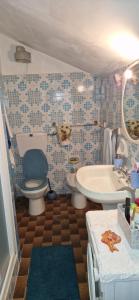 a bathroom with a toilet and a sink and a tub at Casa Sofia in Pamparato