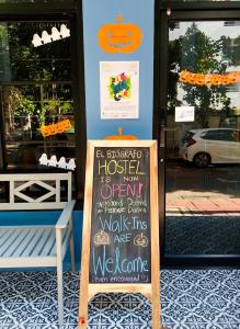 a chalkboard sign in front of a store at El biógrafo in Bangkok