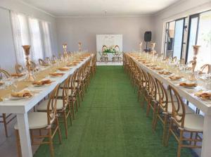 a long table set up for a banquet in a room at Matholeng Gardens Guesthouse in Foso