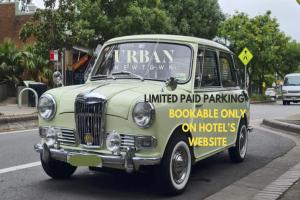 an old green van is parked on a street at The Urban Newtown in Sydney