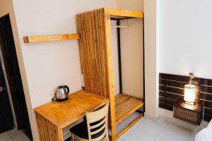 a room with a wooden desk with a kettle on it at Mao Home in Ho Chi Minh City