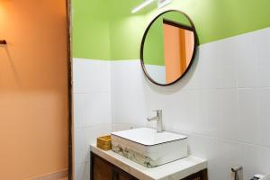 a bathroom with a sink and a mirror at Mao Home in Ho Chi Minh City