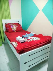 a small bed with a red comforter on it at Burjuman metro PARTITION Private room - 243-03# in Dubai