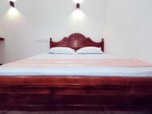 A bed or beds in a room at Nirwana Resort