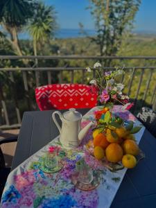 a table with a teapot and some fruit on it at Magical space Tsikhisdziri in Ts'ikhisdziri