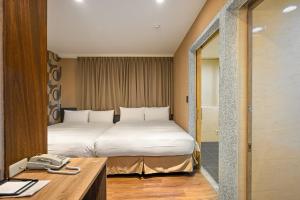 a hotel room with a bed and a telephone at 綺樂文旅 康定館 Le Room Hotel Kangding in Taipei