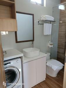 a bathroom with a washing machine and a sink at Tree Homestay in Da Nang