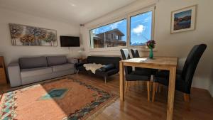 a living room with a table and a couch at Imhof Alpine B&B Apartments in Bettmeralp