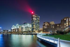 a city skyline at night with a bridge over a river at W Hoboken in Hoboken