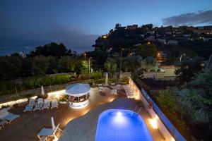 a view of a swimming pool at night at Eden Bleu in Vico Equense