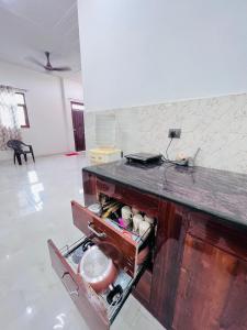 a kitchen with a wooden counter top in a room at Nirmal sadan Homestay in Kāman