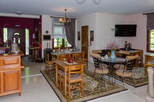 a dining room with wooden tables and chairs at To Kallion in Karpenisi