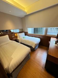 Postel nebo postele na pokoji v ubytování 盤古捷旅 - Panco Hotel