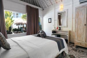 a bedroom with a bed with a stuffed animal on it at Easy Surf Camp in Kuta