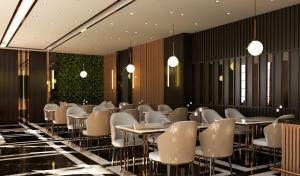 a dining room with tables and chairs and plants at Elite World GO Van Edremit in Van
