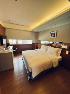 Postel nebo postele na pokoji v ubytování 盤古捷旅 - Panco Hotel